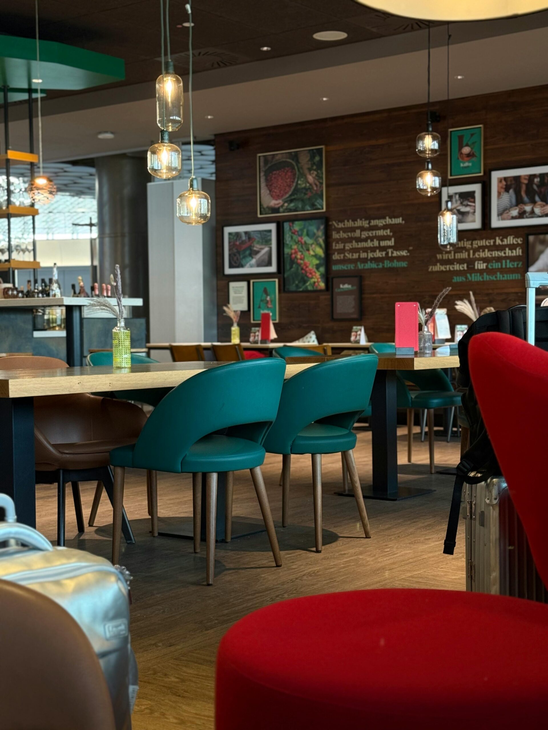 Inviting café interior featuring modern design with colorful chairs and warm lighting.